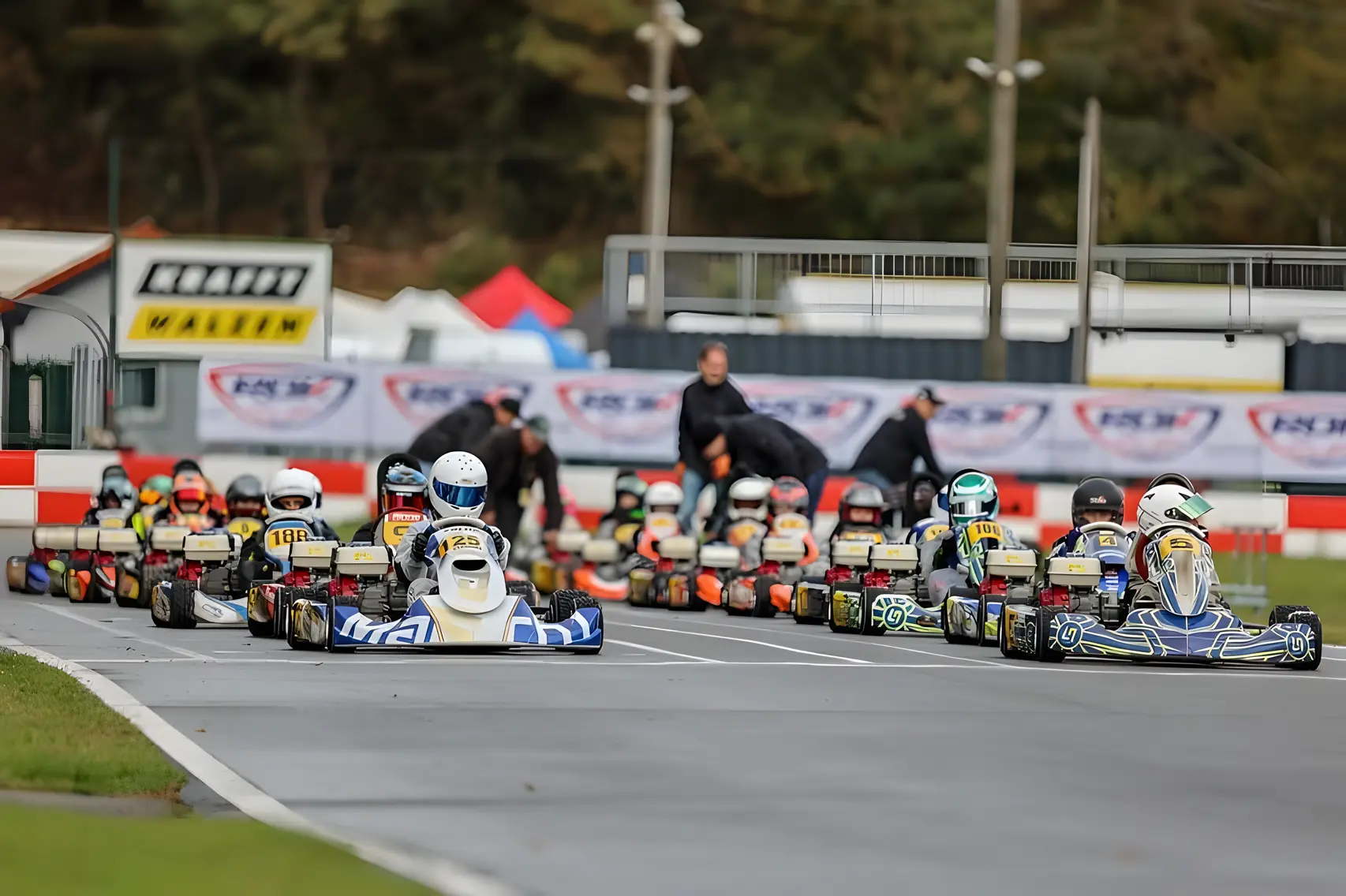 Go-Kart drivers lined up on the starting grid, ready for the race